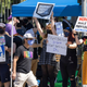 People holding up pro-worker signs outside of Blizzard's main office.